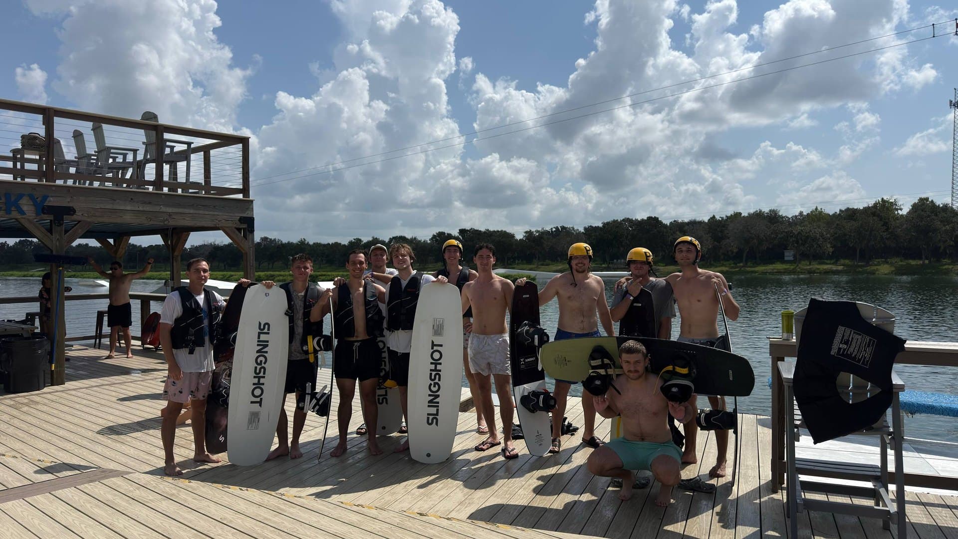 Large Tampa Bay 20s group with wakeboards by the water